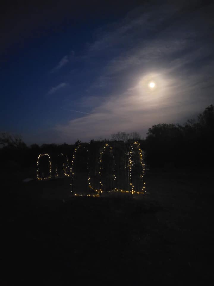 The meme appears to be a dark image with a faint glow in the center. The text "I can see the moon" is likely typed in a bold, white font, but it's not visible due to the dark background. The image is likely a play on words, referencing the phrase "I can see in the dark," but replacing "in" with "the moon" to create a pun.
